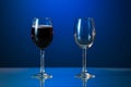 Red wine glass and white wine glass isolated on a blue background Royalty Free Stock Photo