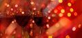 Red wine glasses against christmas lights bokeh background Royalty Free Stock Photo