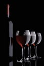 Red wine glasses and bottle on black Royalty Free Stock Photo