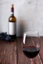 Red wine glasses and bottle on wooden background Royalty Free Stock Photo