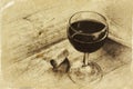 Red wine glasson wooden table. vintage filtered image. black and white style photo