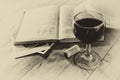 Red wine glasson wooden table. vintage filtered image. black and white style photo Royalty Free Stock Photo