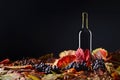 Red wine, grapes and dry vine leaves . Royalty Free Stock Photo