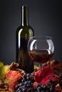 Red wine , grapes and dry vine leaves . Royalty Free Stock Photo