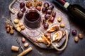 Red wine with grapes, meat, glass a glass on a wooden Board