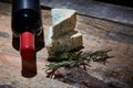 Red wine and ingredients for romantic dinner on the wooden background. Cheese and bread Royalty Free Stock Photo