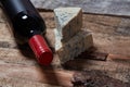 Red wine and ingredients for romantic dinner on the wooden background. Cheese and bread Royalty Free Stock Photo