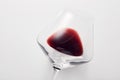 Red wine is inside stemware isolated on light gray. Royalty Free Stock Photo
