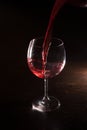 Red wine in motion on black background