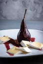 Red Wine Poached Pears in the white plate with cheese and cinnamon Royalty Free Stock Photo