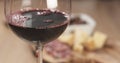 Red wine pour in front of italian antipasti appetizers Royalty Free Stock Photo