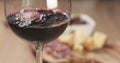 Red wine pour in front of italian antipasti appetizers Royalty Free Stock Photo