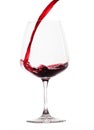 Red wine poured into glas (white background)