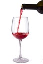 Red wine is poured into a glass from a bottle, isolate on a white background, Royalty Free Stock Photo
