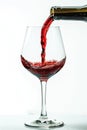 Red wine poured into glass, isolated on white background. AI Generated Royalty Free Stock Photo