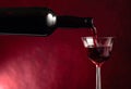 Red wine is poured from an old bottle into a crystal glass Royalty Free Stock Photo