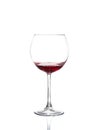 Red wine pouring from bottle into big glass Royalty Free Stock Photo