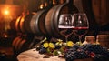 red wine pouring from bottle into glass with old wooden barrel as background at the winery Royalty Free Stock Photo