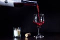 Red wine pouring from the bottle to the glass with splashes Royalty Free Stock Photo