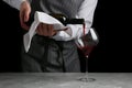 Red wine pouring in glass. bartender on waiter concept on black background Royalty Free Stock Photo