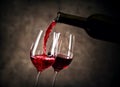 Red wine pouring into glass from bottle Royalty Free Stock Photo