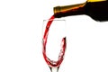 Red wine is pouring into a glass from a bottle Royalty Free Stock Photo