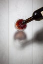 Red wine pouring into glass from bottle Royalty Free Stock Photo