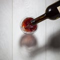 Red wine pouring into glass from bottle Royalty Free Stock Photo