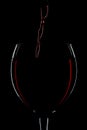 Red wine pouring into glass silhouette Royalty Free Stock Photo