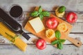 Red wine, raw pasta, tomatoes, basil leaves and cheese. Royalty Free Stock Photo