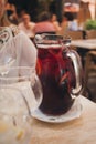 Red wine sangria or punch with fruits and ice in glass. Homemade refreshing fruit sangria on white table in restaurant Royalty Free Stock Photo