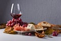 Red wine with snack and grapes . Royalty Free Stock Photo