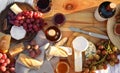 Red wine and snacks served for picnic on wooden table outdoors, flat lay Royalty Free Stock Photo