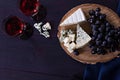 Red wine and snacks. Wine, grapes, cheese, nuts, olives. Romantic evening, still life. Royalty Free Stock Photo