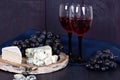 Red wine and snacks. Wine, grapes, cheese, nuts, olives. Romantic evening, still life. Royalty Free Stock Photo