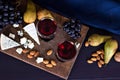 Red wine and snacks. Wine, grapes, cheese, nuts, olives. Romantic evening, still life. Royalty Free Stock Photo