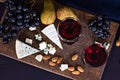 Red wine and snacks. Wine, grapes, cheese, nuts, olives. Romantic evening, still life. Royalty Free Stock Photo