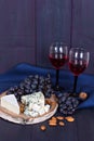 Red wine and snacks. Wine, grapes, cheese, nuts, olives. Romantic evening, still life. Royalty Free Stock Photo