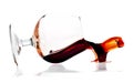 Red wine spilling from a transparent glass Royalty Free Stock Photo