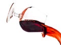 Red wine spilling from a transparent glass Royalty Free Stock Photo