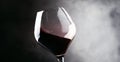 Red wine, splash in a glass, dry cabernet sauvignon, dark background, defocused in motion image, shallow depth of field Royalty Free Stock Photo