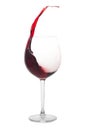 Red wine splashing out of a glass, isolated on white Royalty Free Stock Photo