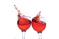 Red wine splash in two glasses, isolated on a white Royalty Free Stock Photo