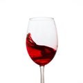 Red wine splashing in an elegant glass on a white background Royalty Free Stock Photo