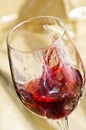 Red wine is splashing in glass Royalty Free Stock Photo