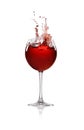 Red wine splashing in glass on background Royalty Free Stock Photo