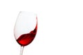 Red wine splashing gracefully in a tilted glass Royalty Free Stock Photo