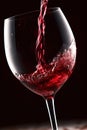 red wine splashing out of a glass, isolated on black background. Royalty Free Stock Photo