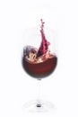 Red wine splashing out of a glass Royalty Free Stock Photo