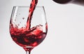 Red wine splashing out of a glass, isolated on white background Royalty Free Stock Photo